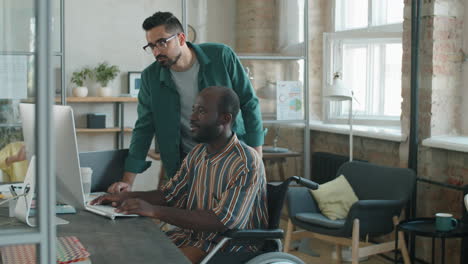 Middle-Eastern-Businessman-Working-with-African-American-Colleague-in-Wheelchair